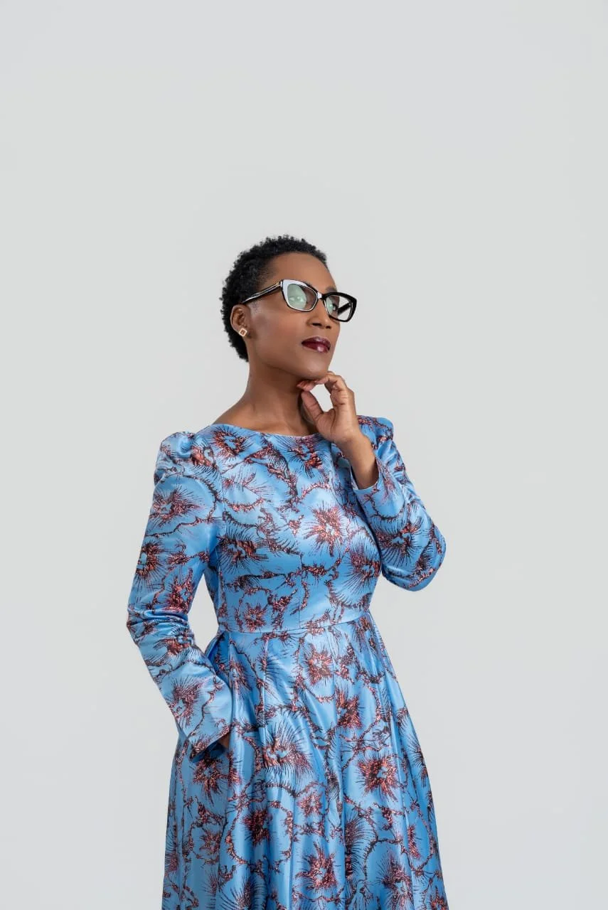 Rolanda Desir Andre wearing a blue patterned dress