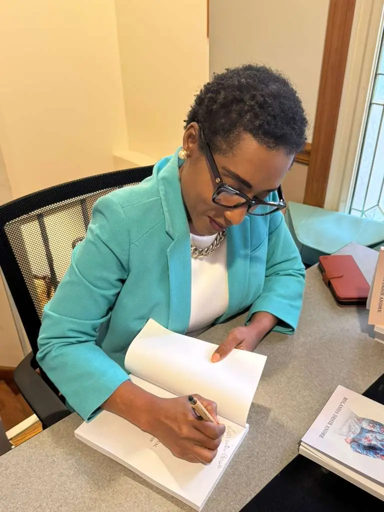 Rolanda signing a copy of The 12 P's