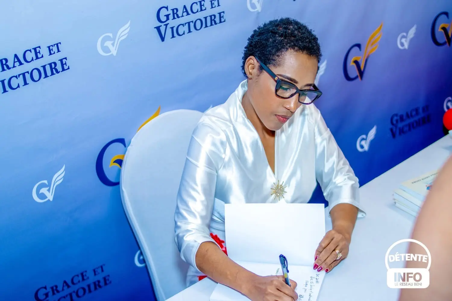 Rolanda signing a copy of The 12 P's